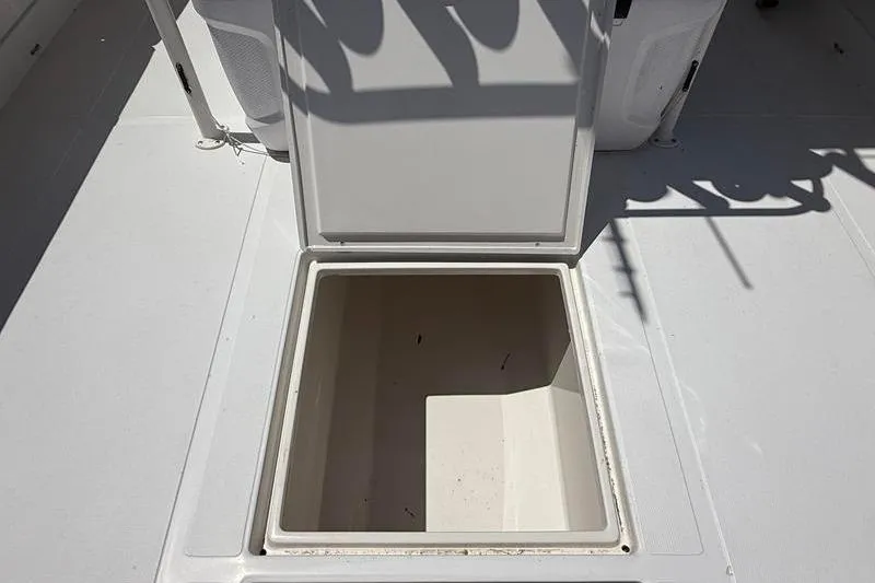 Slide: The Image of Open storage compartment on 2003 Jupiter 31 Cuddy boat deck. - 17