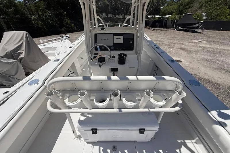 Slide: The Image of 2003 Jupiter 31 Cuddy boat interior with steering console and rod holders. - 18