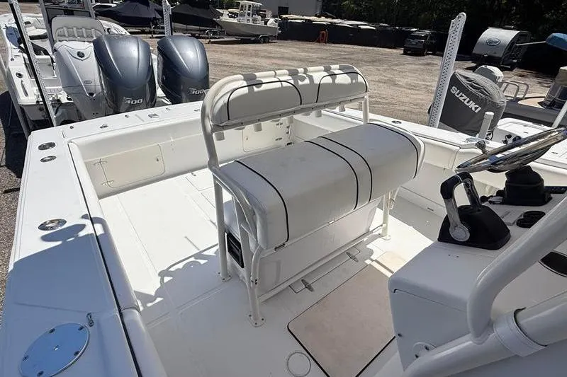 Slide: The Image of 2003 Jupiter 31 Cuddy boat interior with seating and dual outboard engines. - 22