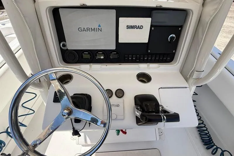Slide: The Image of Control panel of a 2003 Jupiter 31 Cuddy boat with Garmin and Simrad systems. - 23