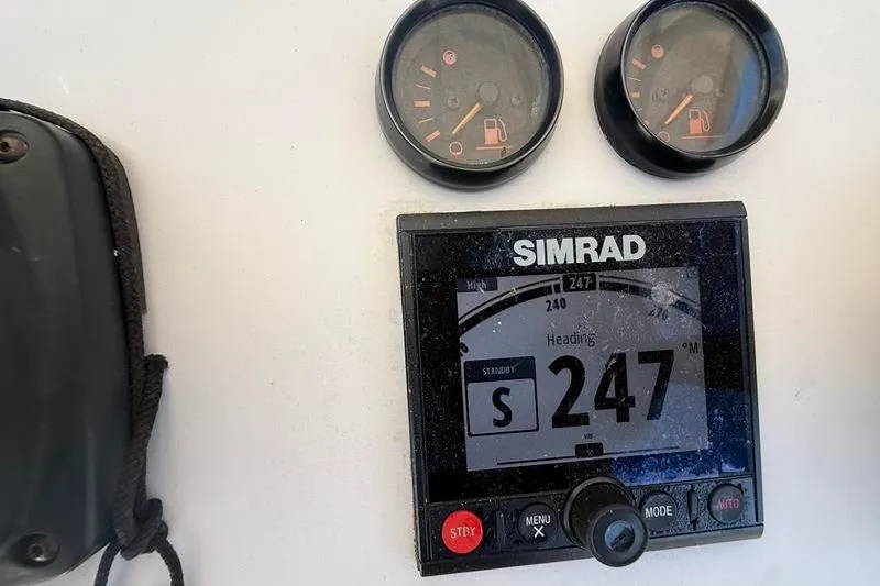 Slide: The Image of Simrad navigation display and gauges on a 2003 Jupiter 31 Cuddy boat. - 25