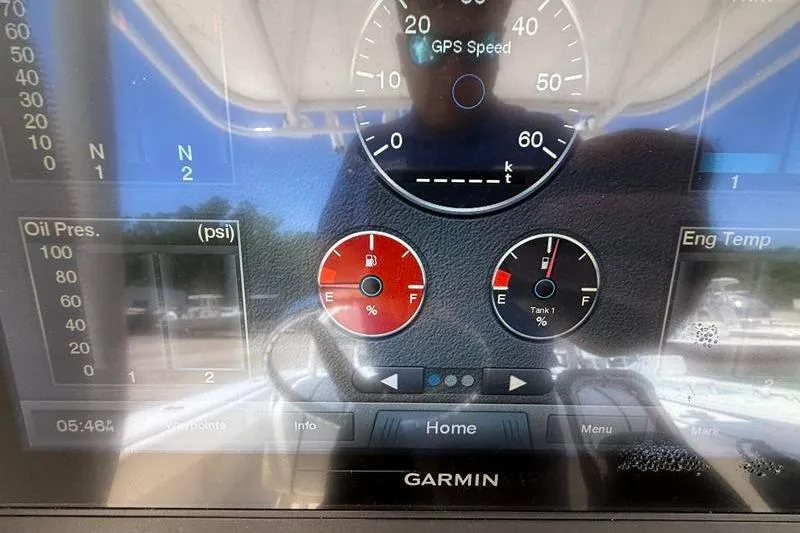 Slide: The Image of Garmin marine display showing GPS speed, fuel levels, and engine metrics on a 2003 Jupiter 31 Cuddy. - 29
