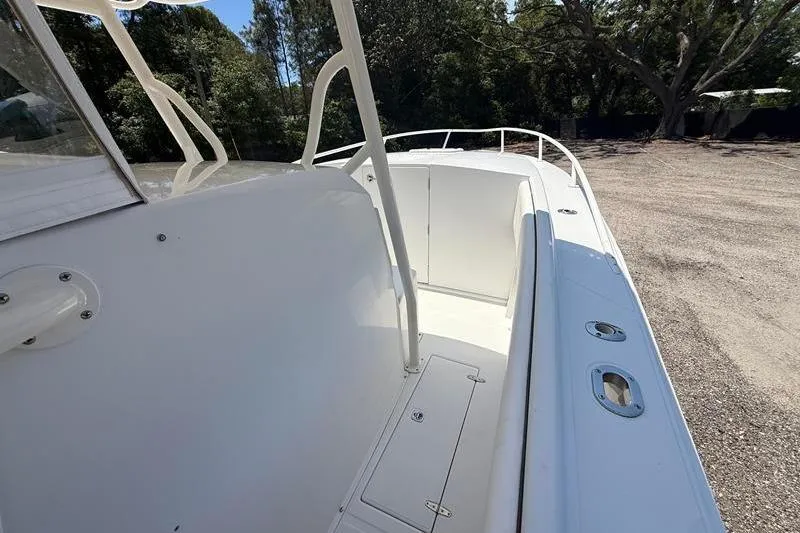 Slide: The Image of 2003 Jupiter 31 Cuddy boat, white deck, spacious layout, surrounded by trees. - 35