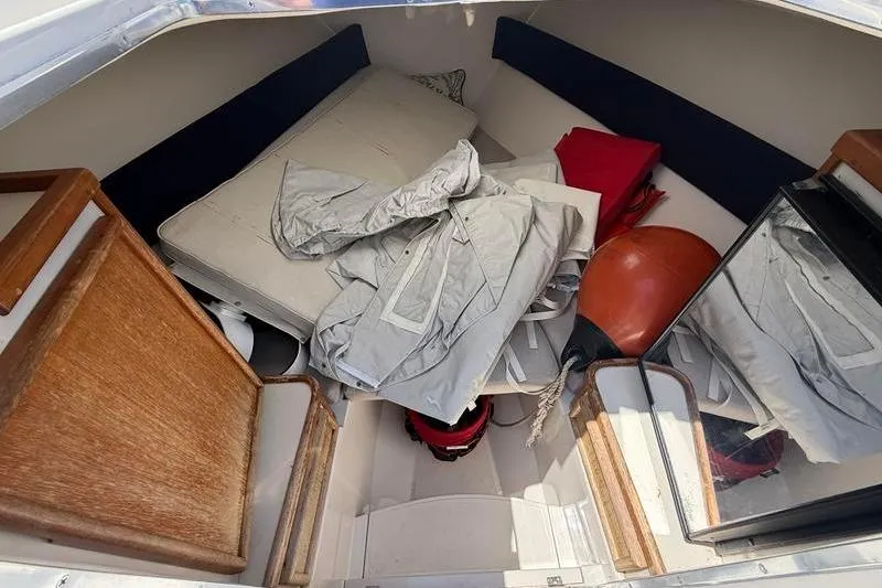 Slide: The Image of 2003 Jupiter 31 Cuddy cabin interior with cushions and boating gear. - 38