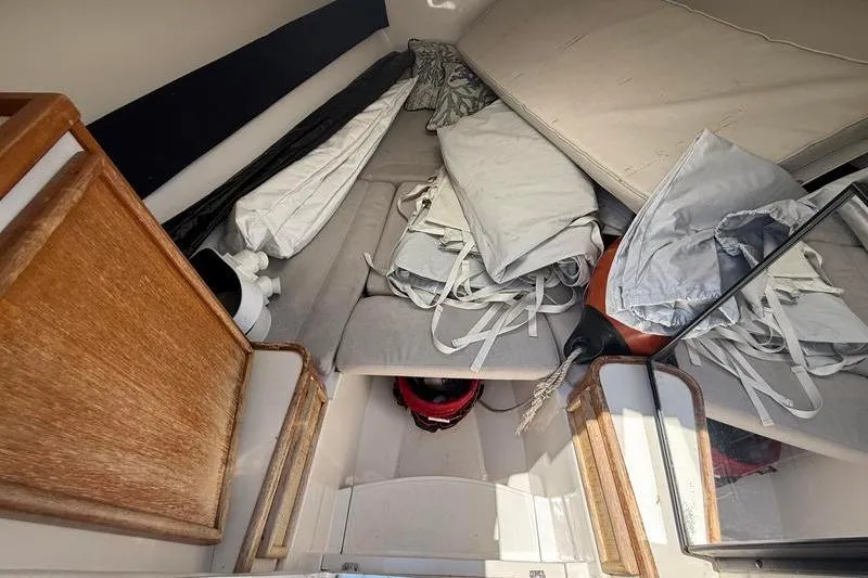 Slide: The Image of Interior of 2003 Jupiter 31 Cuddy boat with cushions and gear storage. - 39