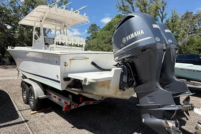 Slide: The Image of 2003 Jupiter 31 Cuddy boat with dual Yamaha engines on a trailer. - 4