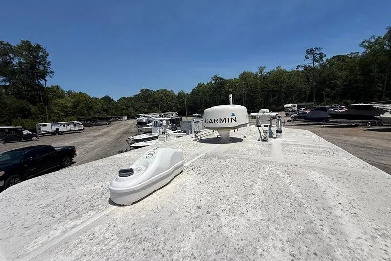 Slide: The Image of 2003 Jupiter 31 Cuddy boat with Garmin equipment in a storage yard. - 41