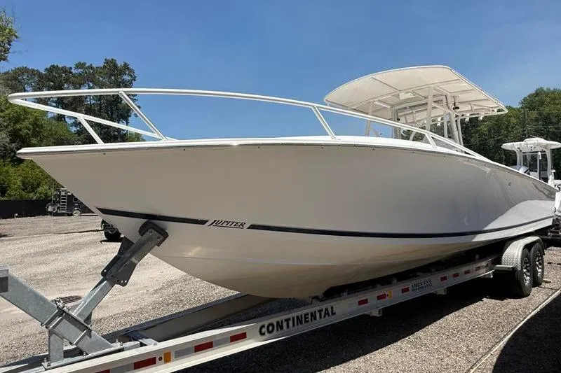 Slide: The Image of 2003 Jupiter 31 Cuddy boat on trailer, parked outdoors under clear sky. - 6