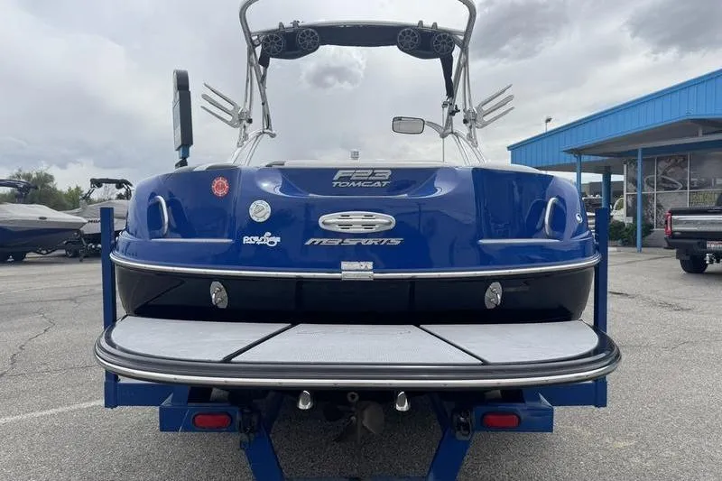 Slide: The Image of 2007 MB TOMCAT F23 boat, blue exterior, parked on trailer in outdoor setting. - 10