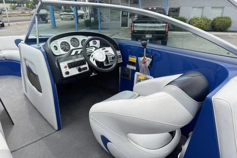 Slide: The Image of Interior of a 2007 MB TOMCAT boat with steering wheel and dashboard controls. - 11