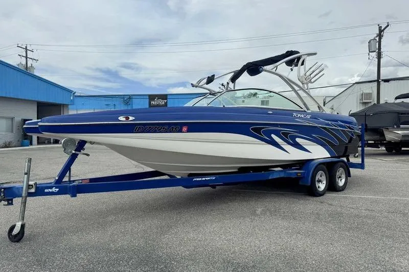 Slide: The Image of Blue and white 2007 MB TOMCAT boat on trailer in parking lot. - 17