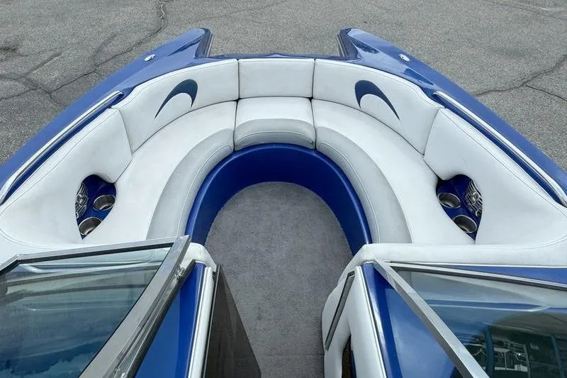 Slide: The Image of 2007 MB TOMCAT boat interior with blue and white seating and cup holders. - 23