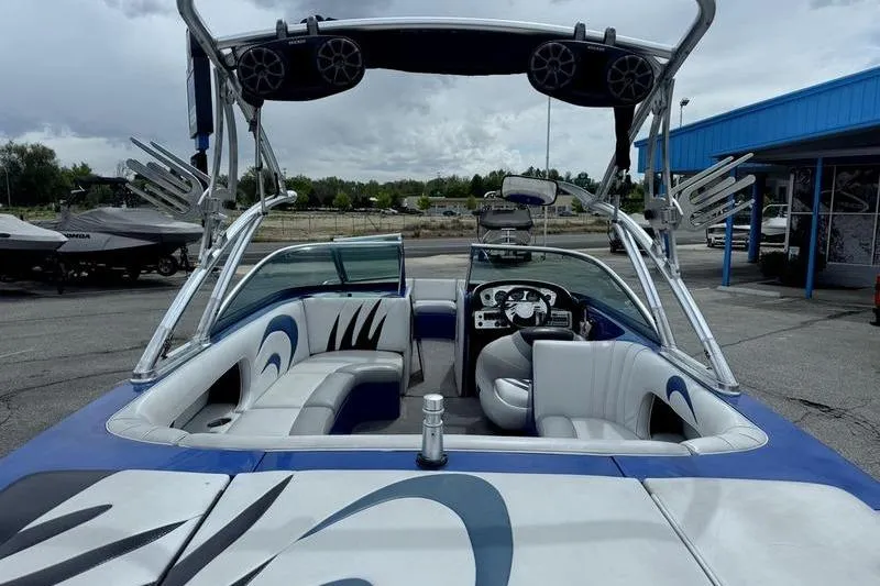 Slide: The Image of 2007 MB TOMCAT boat interior with seating and speakers, parked outdoors. - 5