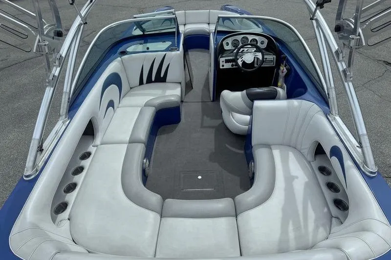 Slide: The Image of Interior of a 2007 MB TOMCAT boat with sleek seating and modern dashboard. - 9