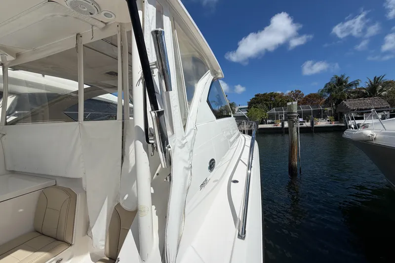 Slide: The Image of 2018 Pursuit OS 355 Offshore boat docked, showcasing sleek design and spacious interior. - 10