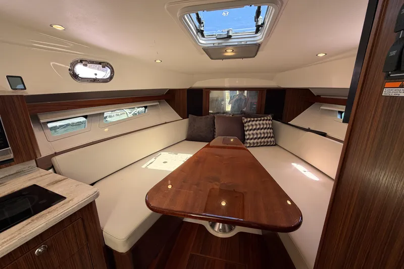 Slide: The Image of Luxurious interior of 2018 Pursuit OS 355 Offshore boat with elegant seating and wooden table. - 25
