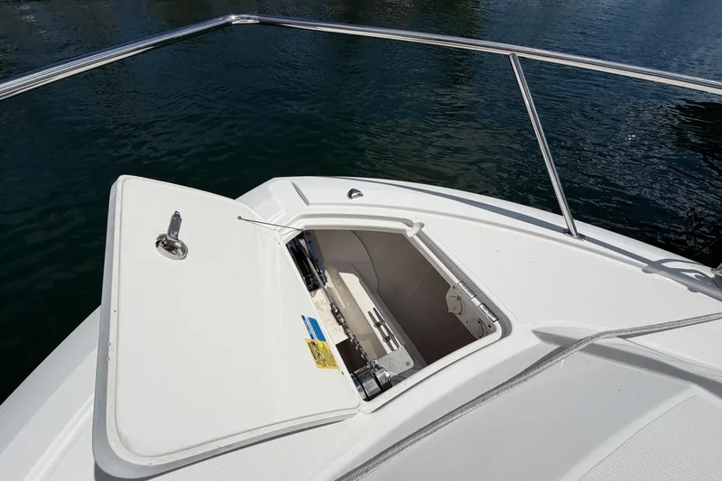 Slide: The Image of 2018 Pursuit OS 355 Offshore boat with open anchor locker on calm water. - 31