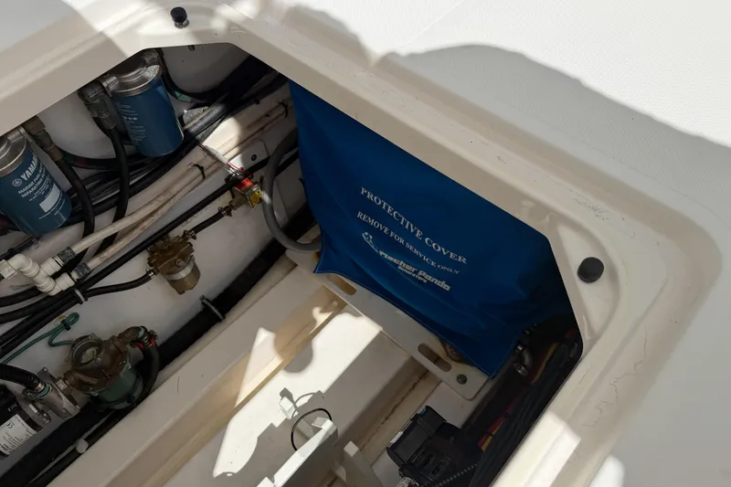 Slide: The Image of Engine compartment of a 2018 Pursuit OS 355 Offshore boat, showing filters and protective cover. - 34