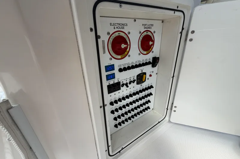 Slide: The Image of Electrical panel of 2018 Pursuit OS 355 Offshore boat with switches and voltage displays. - 35