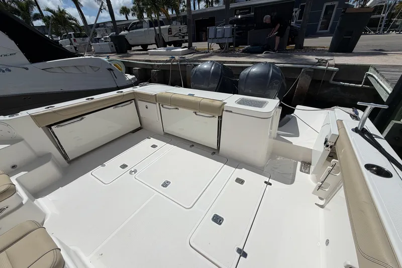 Slide: The Image of 2018 Pursuit OS 355 Offshore boat deck with seating and storage, docked at marina. - 6