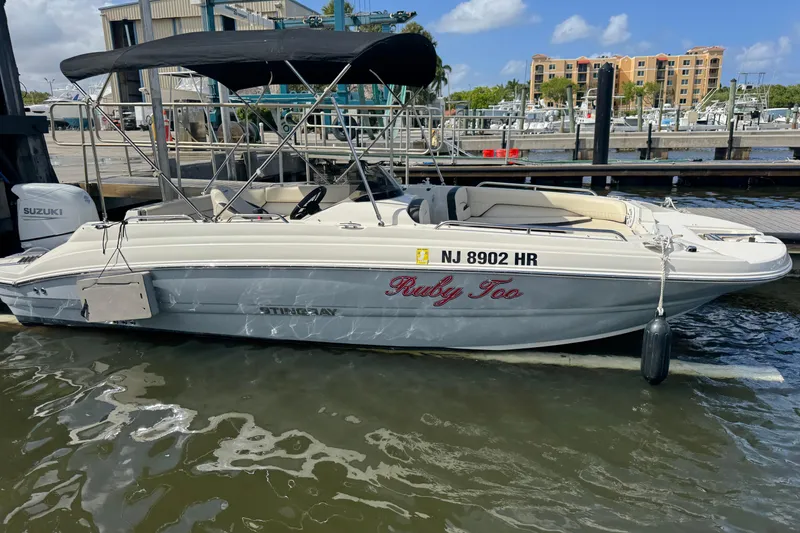 The Image of 2022 Stingray 192 SC boat named "Ruby Too" docked at a marina. - 0