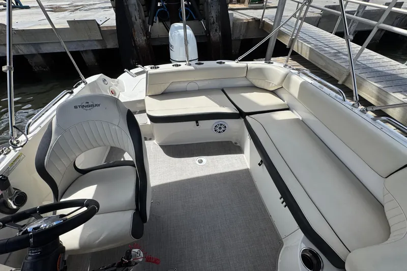 Slide: The Image of 2022 Stingray 192 SC boat interior with seating and steering wheel. - 10
