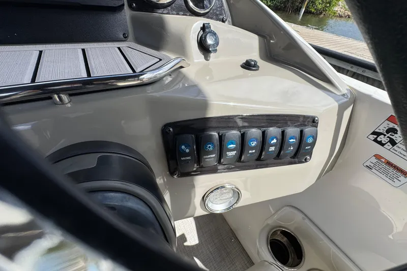 Slide: The Image of Control panel of a 2022 Stingray 192 SC boat with various switches and gauges. - 13