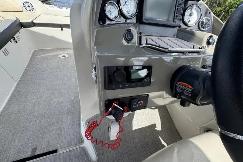Slide: The Image of 2022 Stingray 192 SC boat dashboard with gauges, controls, and steering wheel. - 14
