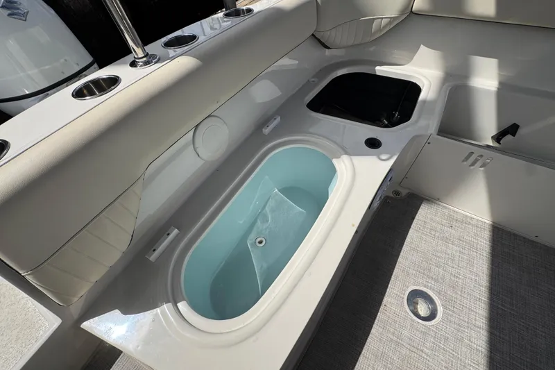Slide: The Image of Interior view of 2022 Stingray 192 SC boat featuring seating and storage compartments. - 19