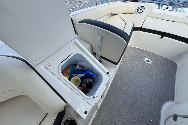 Slide: The Image of 2022 Stingray 192 SC boat interior with storage compartment and seating area. - 25