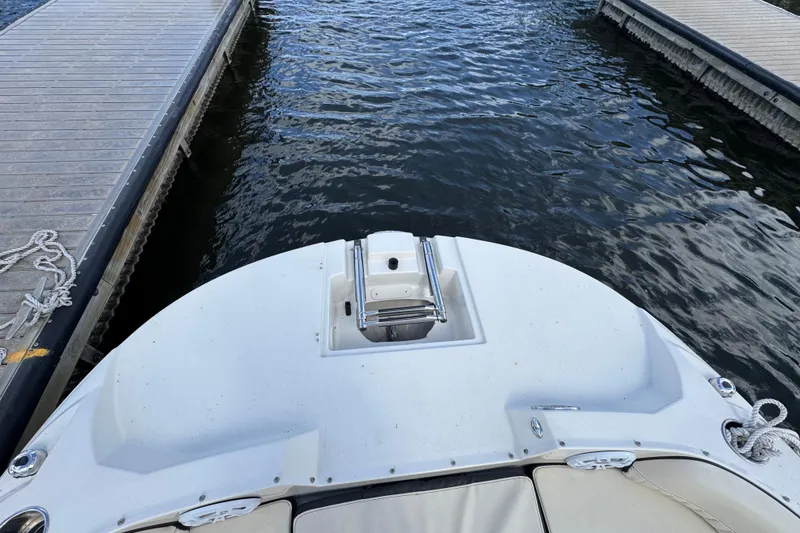 Slide: The Image of 2022 Stingray 192 SC boat docked between piers on calm water. - 32