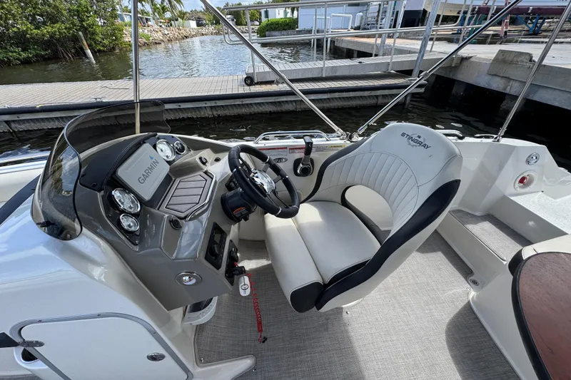 Slide: The Image of 2022 Stingray 192 SC boat cockpit with Garmin navigation system and comfortable seating. - 36