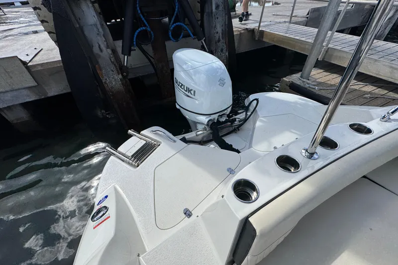Slide: The Image of 2022 Stingray 192 SC boat with Suzuki outboard motor at dockside. - 37