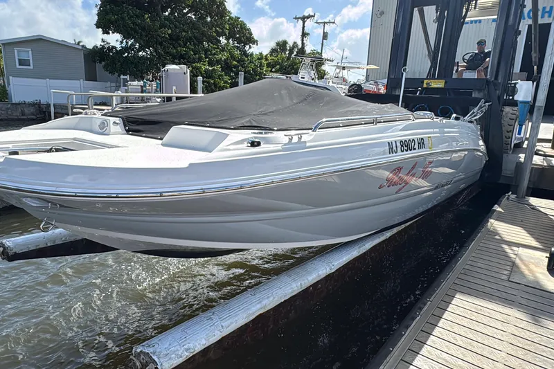 Slide: The Image of 2022 Stingray 192 SC boat docked, covered, with registration NJ 8902 HR visible. - 41