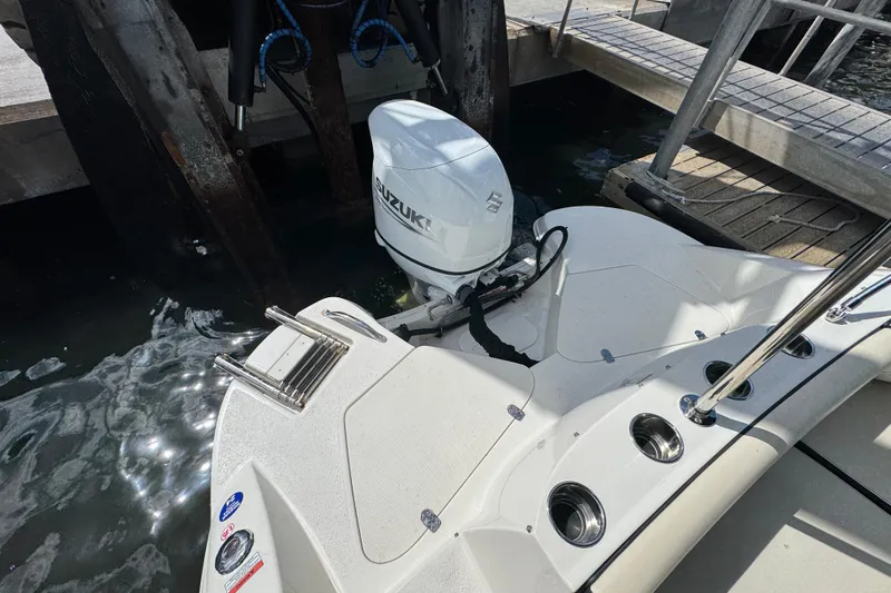Slide: The Image of 2022 Stingray 192 SC boat with Suzuki outboard motor docked at marina. - 6