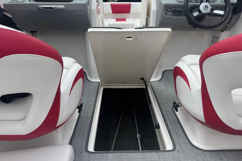 Slide: The Image of 2017 Chaparral 21 H2O Sport boat interior with open storage compartment and red-white seating. - 11