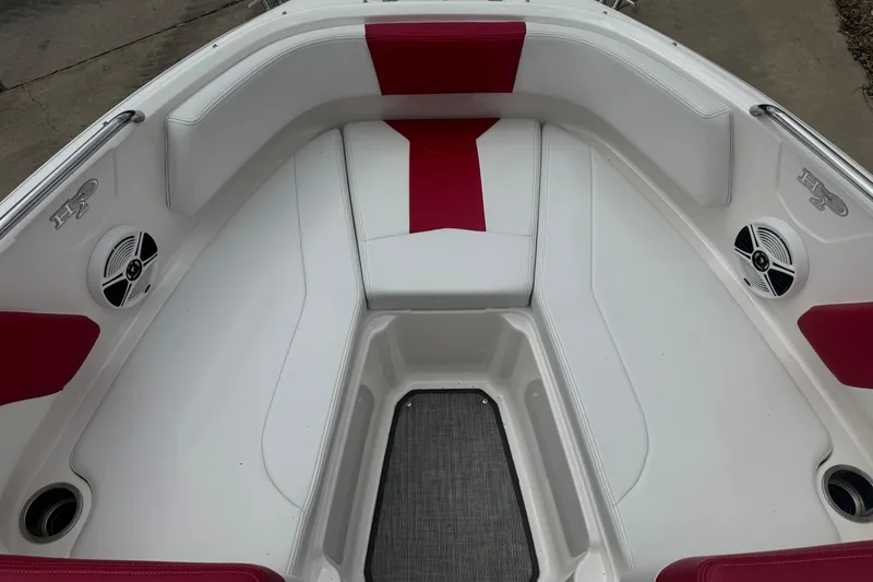 Slide: The Image of 2017 Chaparral 21 H2O Sport boat interior with red and white seating and speakers. - 15