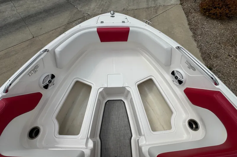Slide: The Image of Bow seating area of 2017 Chaparral 21 H2O Sport with red and white upholstery. - 16