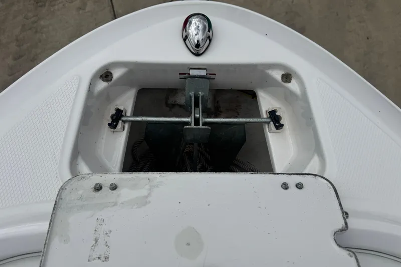 Slide: The Image of Anchor compartment of 2017 Chaparral 21 H2O Sport boat, featuring metal fittings. - 18