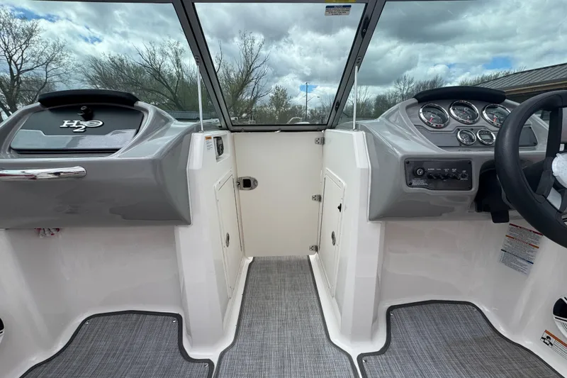 Slide: The Image of 2017 Chaparral 21 H2O Sport boat interior with dashboard and steering wheel. - 19