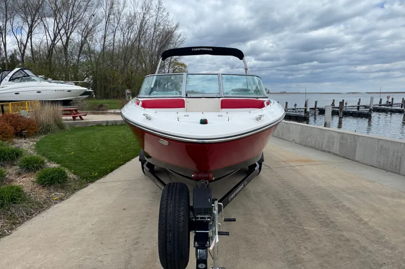 Slide: The Image of 2017 Chaparral 21 H2O Sport boat on trailer by lakeside dock. - 2