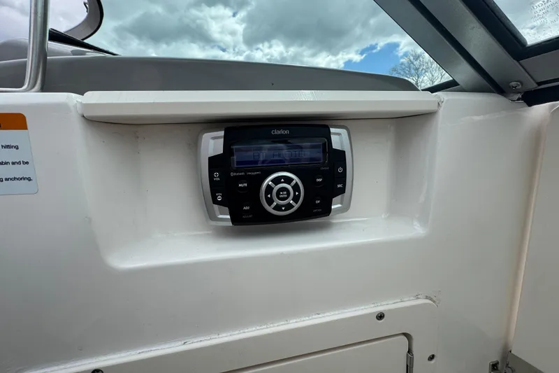 Slide: The Image of Clarion stereo system on 2017 Chaparral 21 H2O Sport boat dashboard. - 20