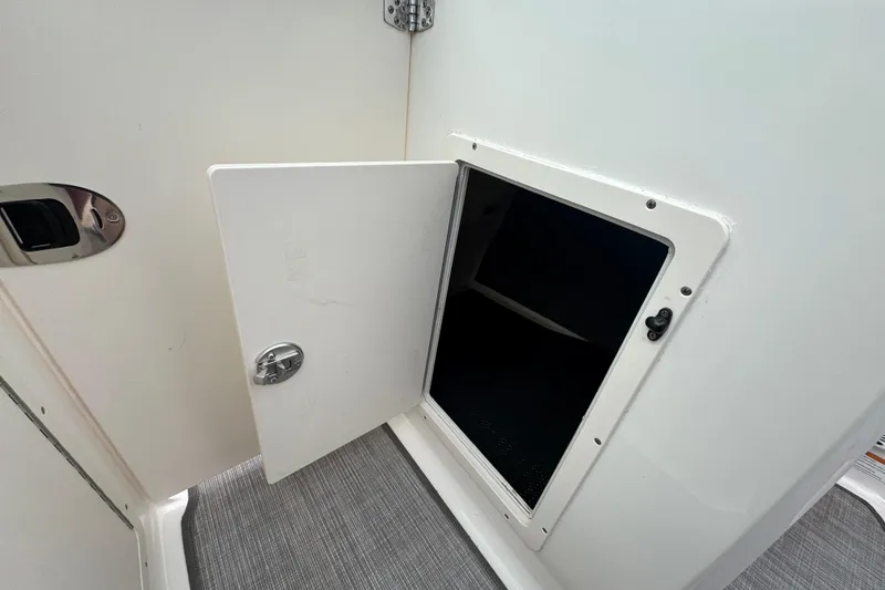 Slide: The Image of Open storage compartment on 2017 Chaparral 21 H2O Sport boat interior. - 22