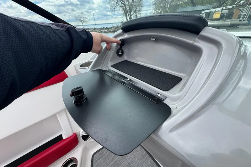 Slide: The Image of 2017 Chaparral 21 H2O Sport dashboard with storage compartment and control panel. - 23