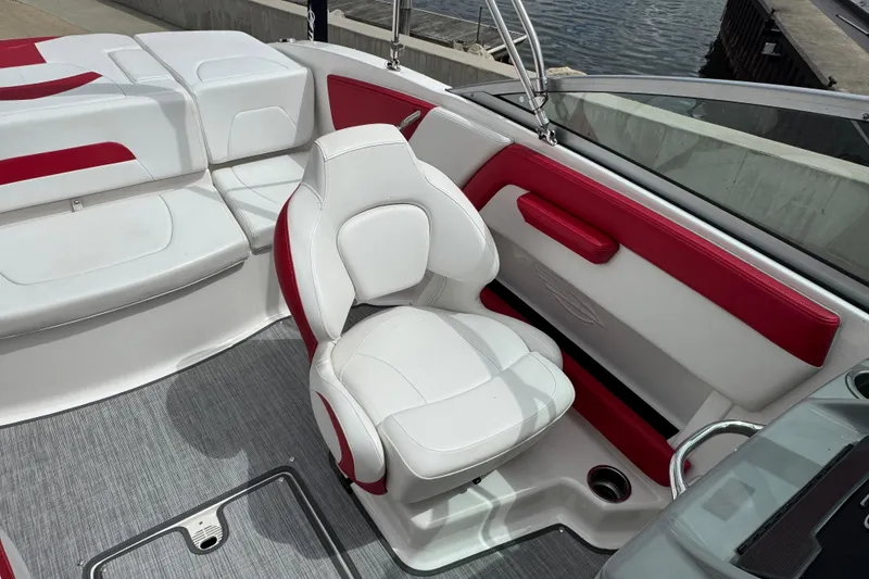 Slide: The Image of 2017 Chaparral 21 H2O Sport boat interior with white and red seating by the water. - 27