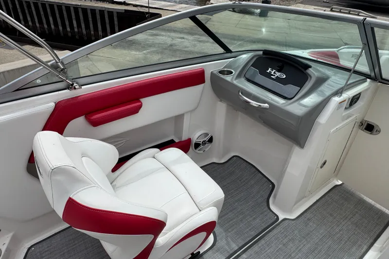 Slide: The Image of 2017 Chaparral 21 H2O Sport boat interior with white and red seating, dashboard view. - 28