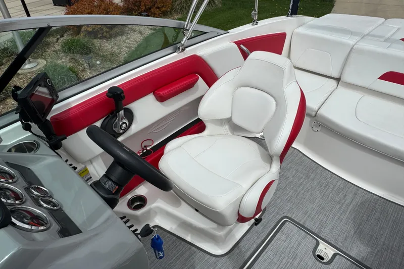 Slide: The Image of 2017 Chaparral 21 H2O Sport boat interior with red and white seating and steering console. - 29