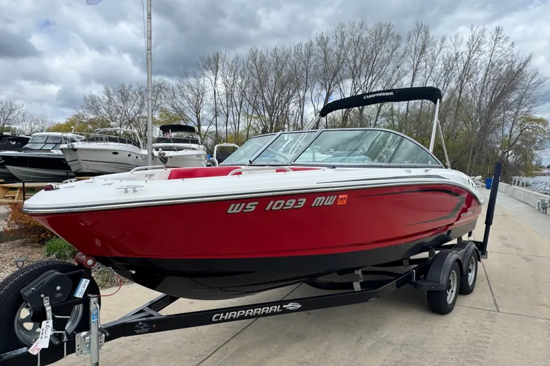 Slide: The Image of 2017 Chaparral 21 H2O Sport boat in vibrant red on trailer, dockside setting. - 3