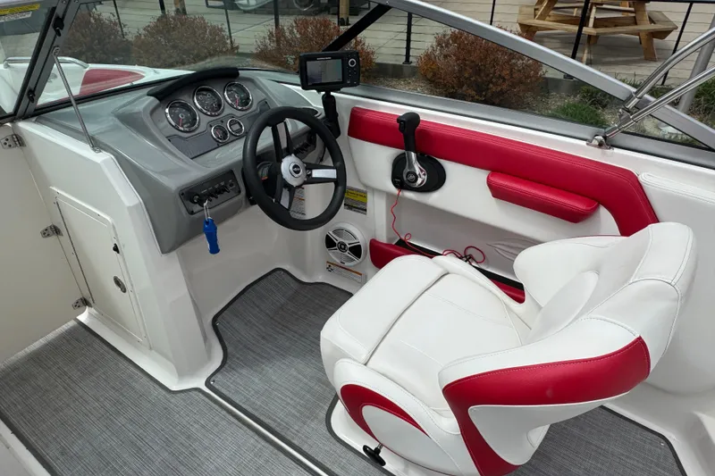 Slide: The Image of 2017 Chaparral 21 H2O Sport boat interior with steering wheel and red accents. - 30