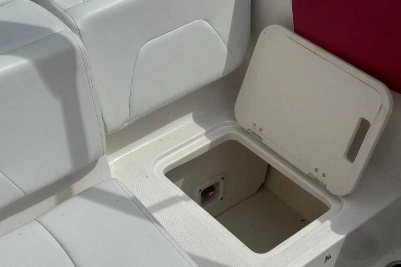 Slide: The Image of 2017 Chaparral 21 H2O Sport boat storage compartment with open lid. - 35